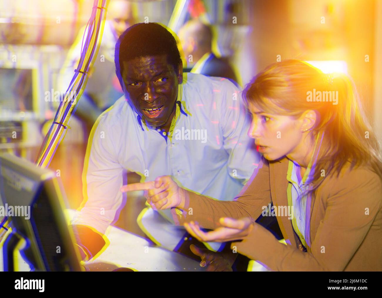 Man and woman in fright looking for a solution on the computer in quest ...