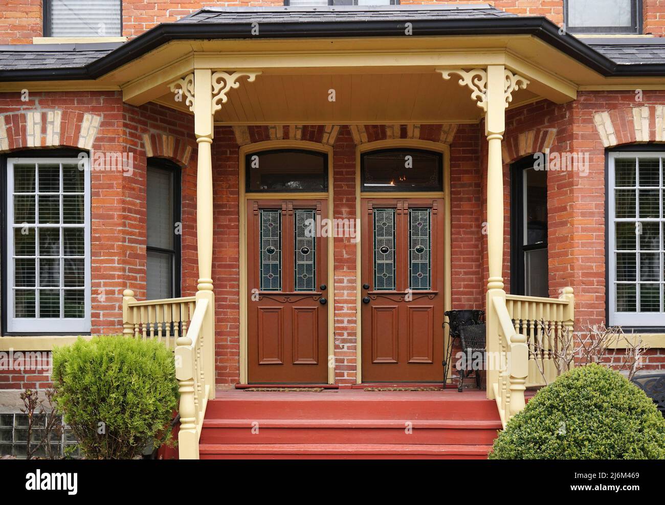 Victorian semi-detached house with large shared front porch Stock Photo
