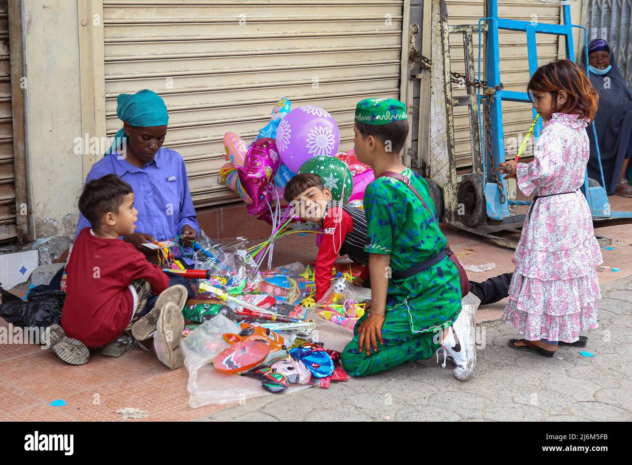 Kenyan Somali children around a street vendor along Jam street in Eastleigh, during Eid-Ul-Fitr celebrations. Muslims in Kenya celebrate Eid-Ul-Fitr which marks the end of the Holy month of Ramadhan. Stock Photo