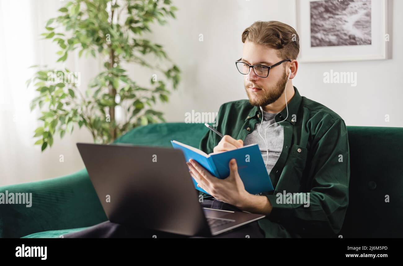 Man using laptop for studying Stock Photo