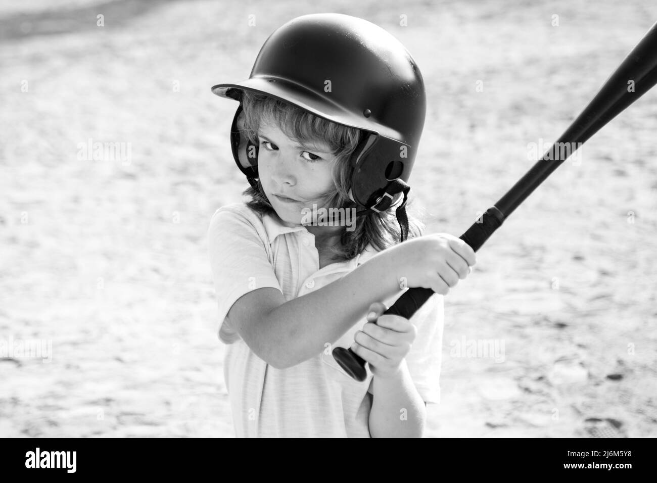 Boy in baseball helmet and baseball bat ready to bat Stock Photo Alamy