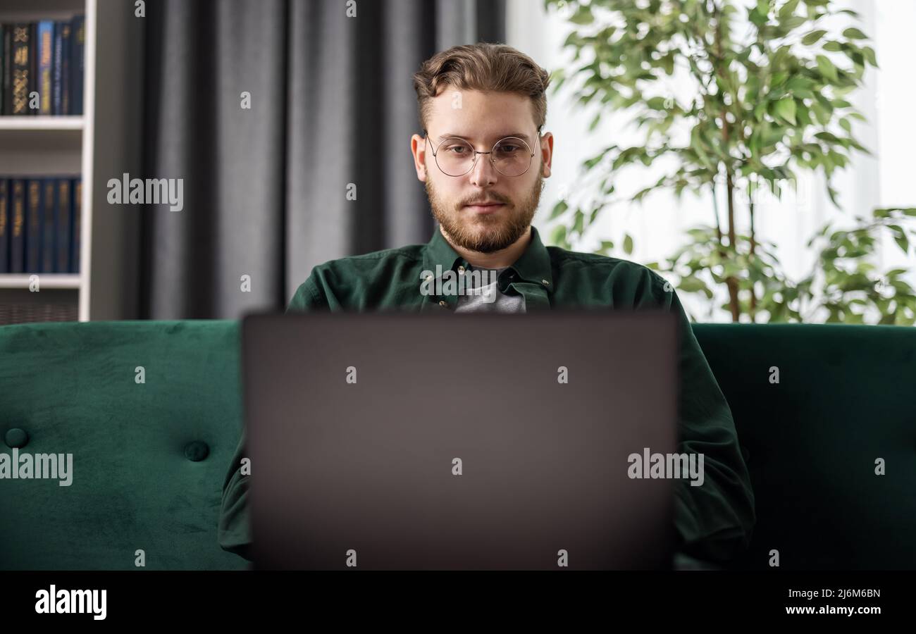 Man with laptop at home Stock Photo