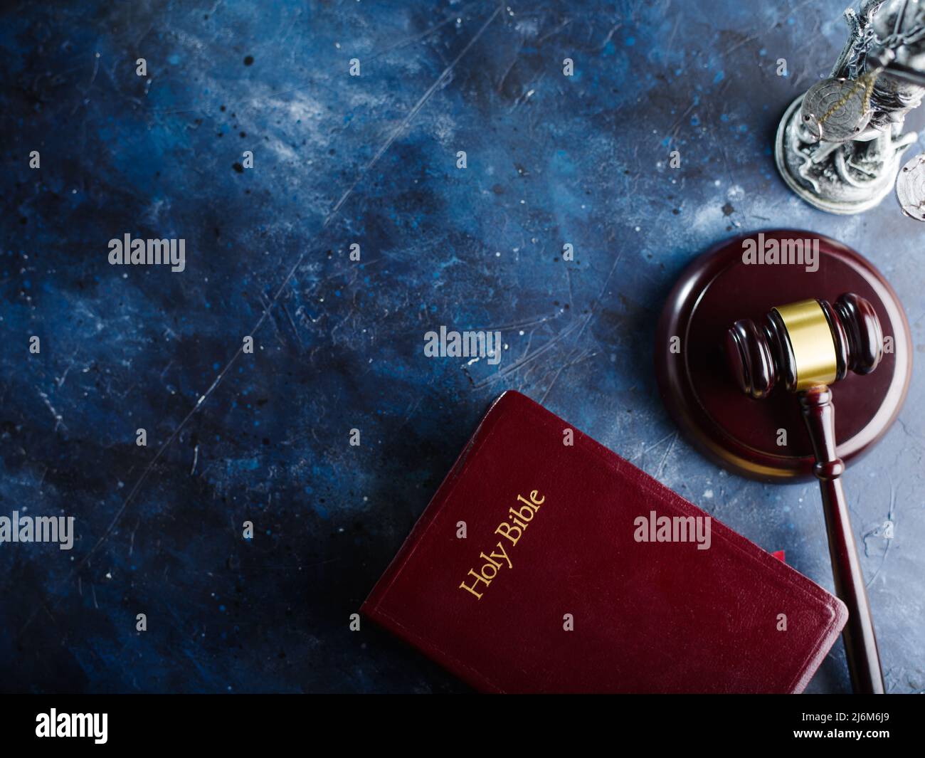 Low angle view Holy bible and judge's gavel on blue marble background. Justice, freedom, equality, fairness, Constitution, presumption of innocence. T Stock Photo