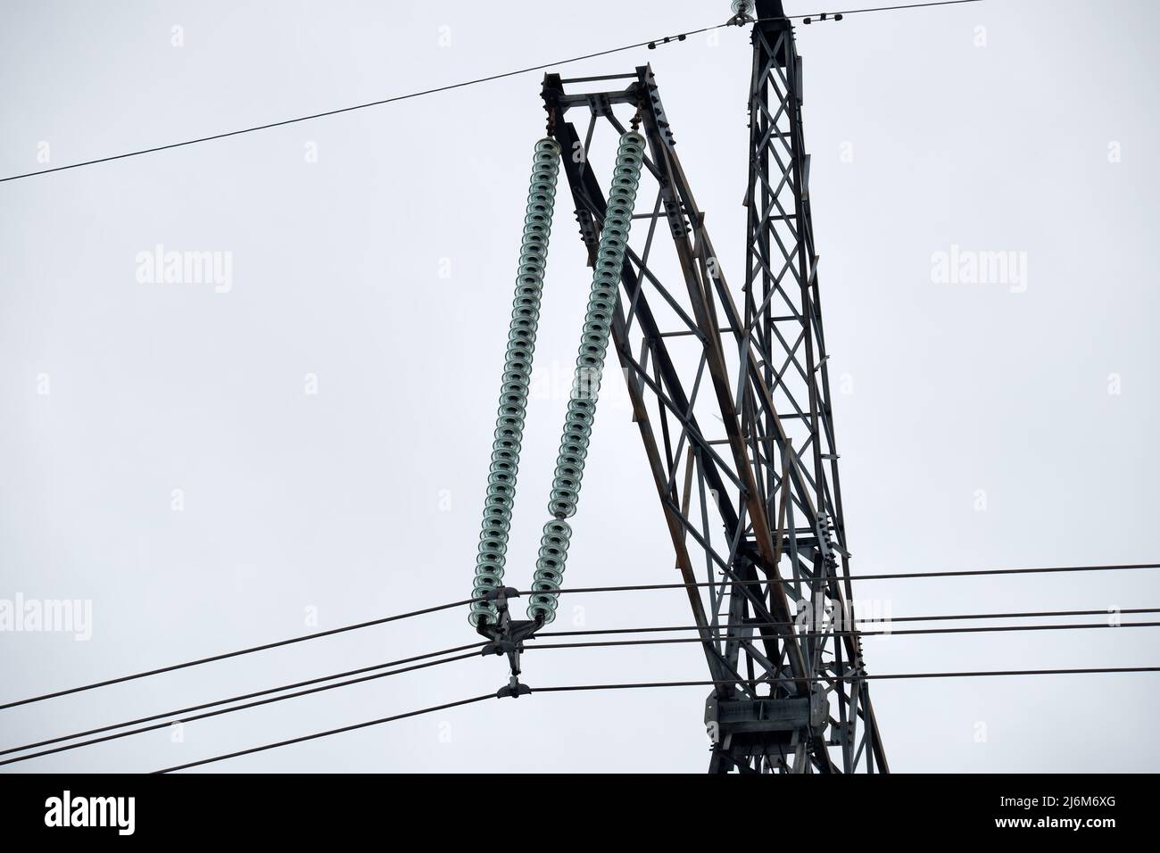 High voltage tower with electric power lines divided by safe guard