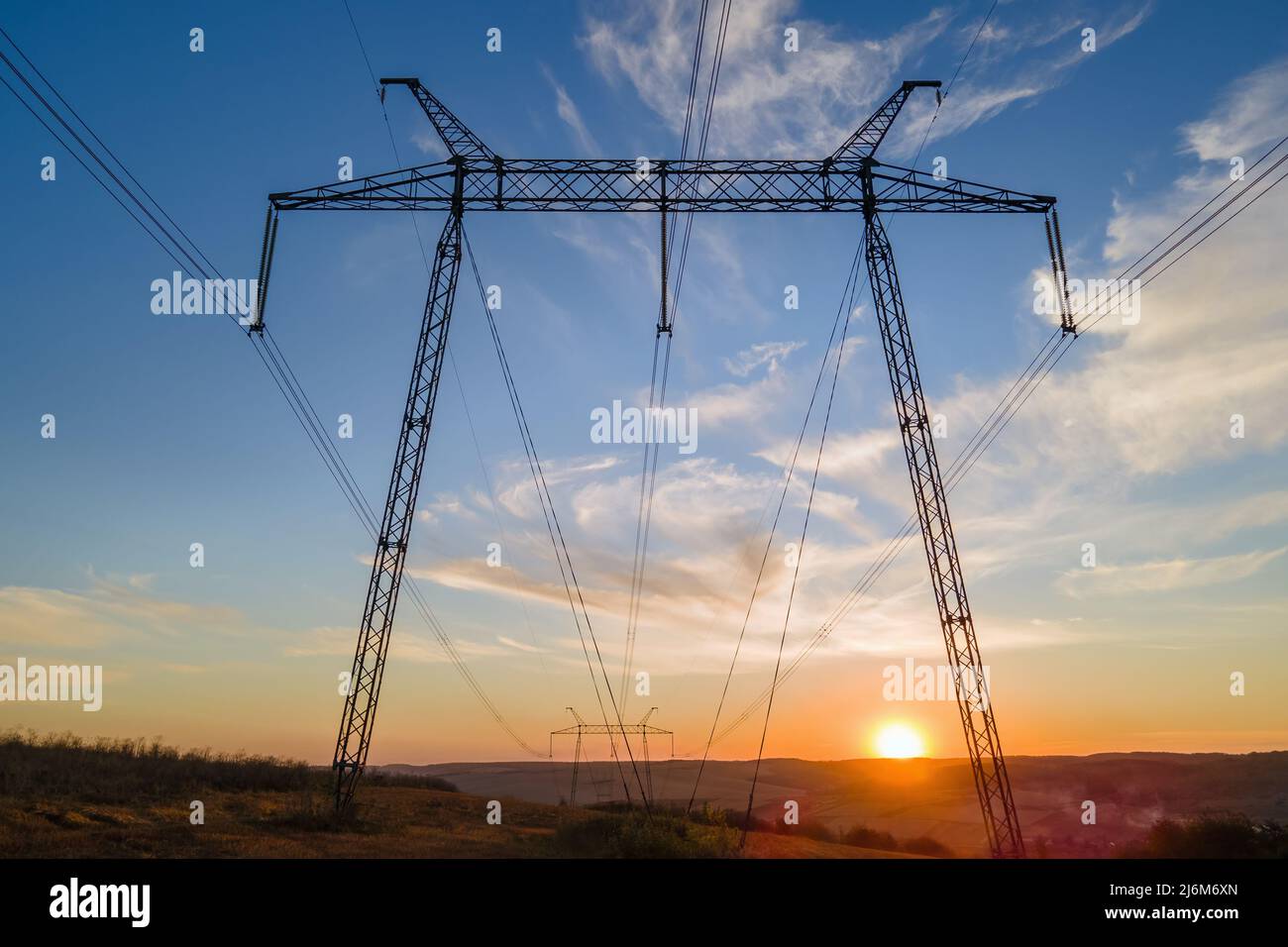 High voltage tower with electric power lines at sunset. Transmission of ...