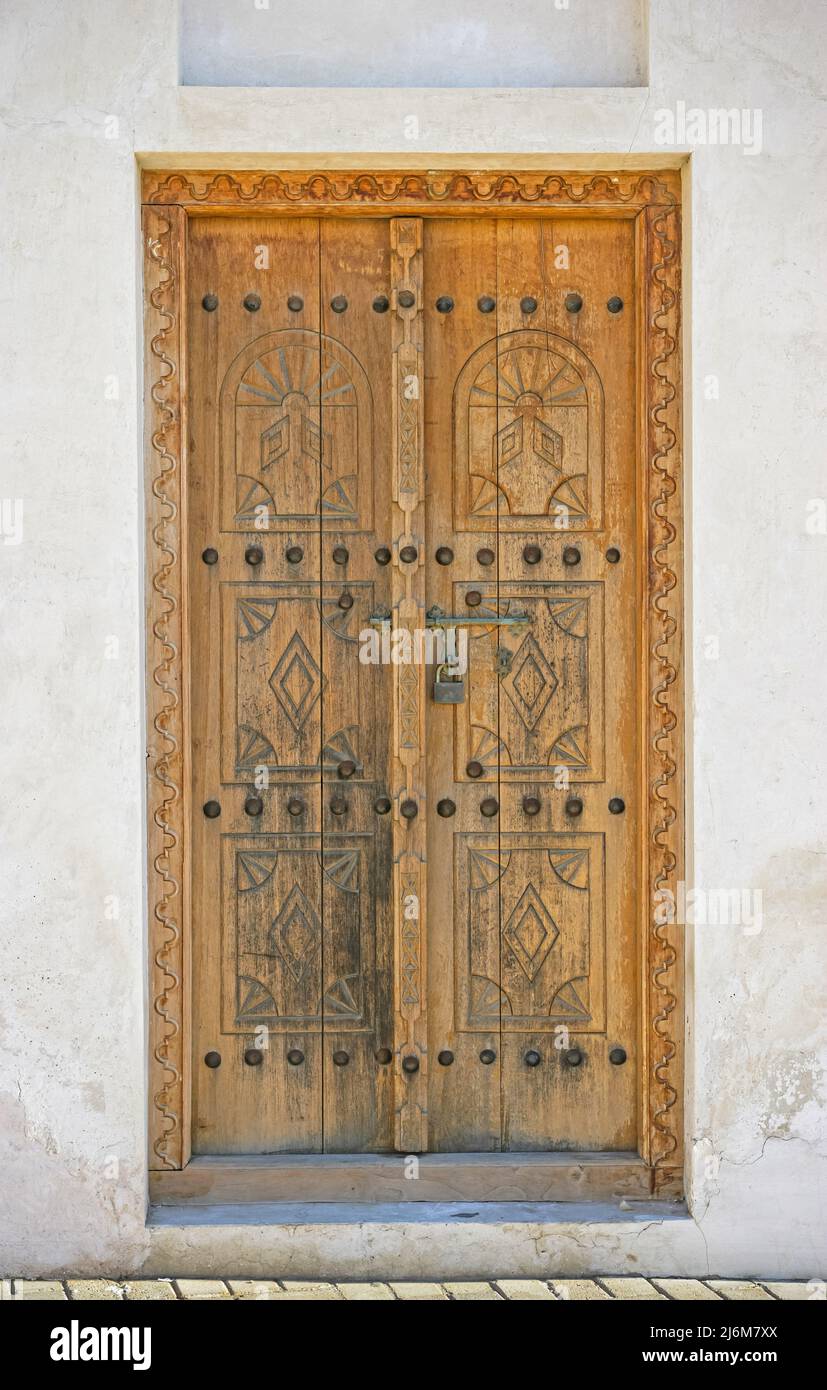 A traditional Arabian doorway in the city of Sharjah's restored Heritage Area in the United Arab Emirates. Stock Photo