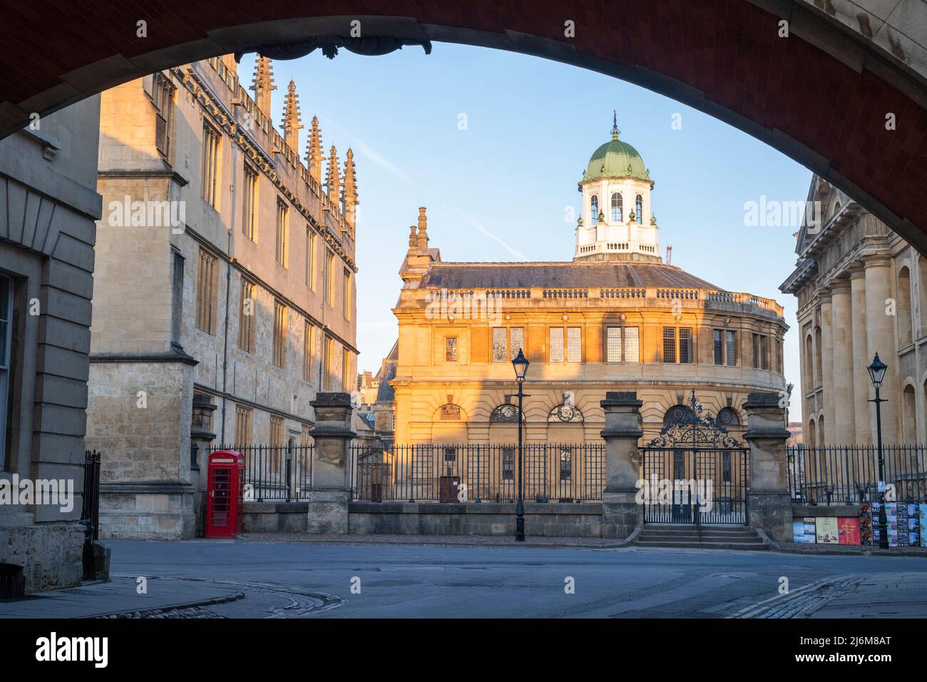 The Sheldonian Theatre from under Hertford Bridge at sunrise in the spring. Oxford, Oxfordshire, England Stock Photo