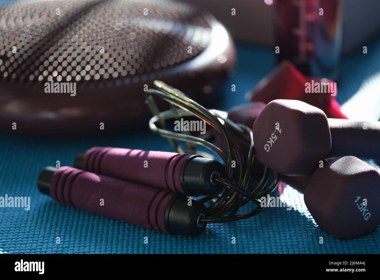 Jump rope and dumbbells, athletes set for workout Stock Photo Alamy