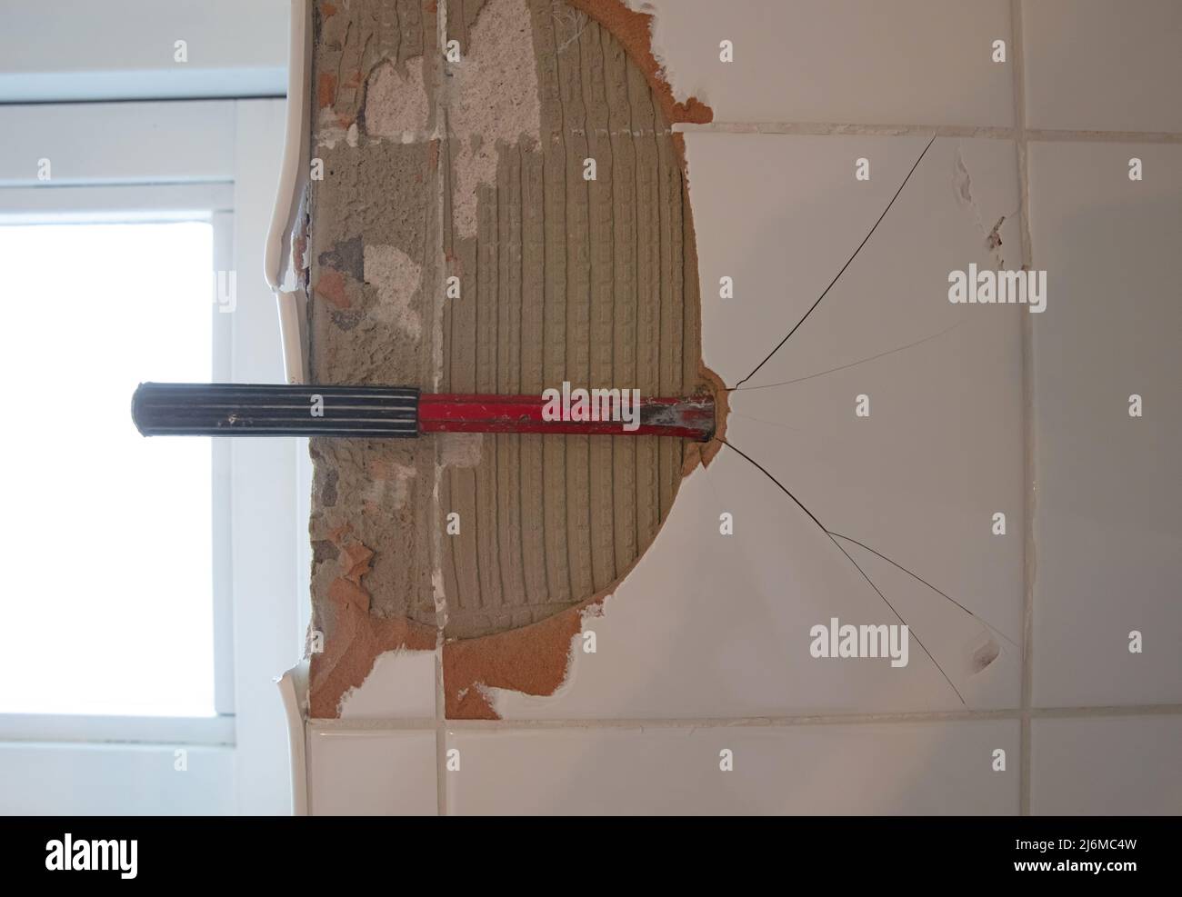 Breaking ceramic tiles, work in progress, maintenance Stock Photo Alamy