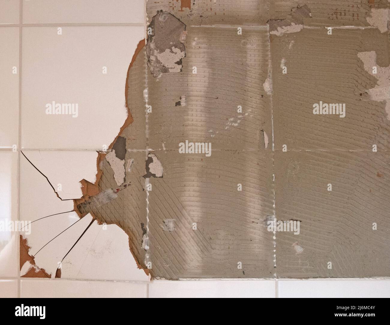 Breaking ceramic tiles, work in progress, maintenance Stock Photo Alamy