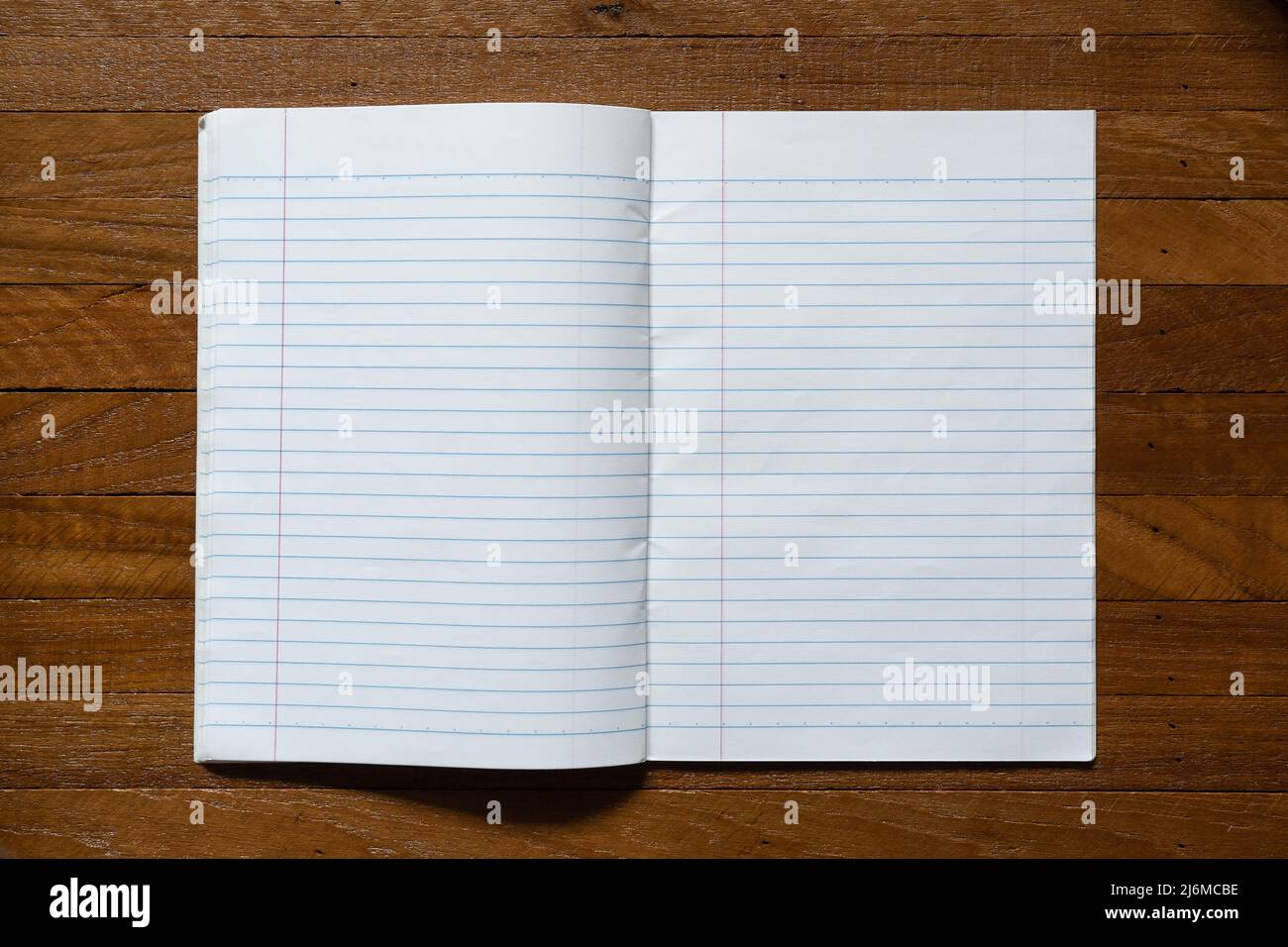 Ruled paper notebook on wooden table Stock Photo