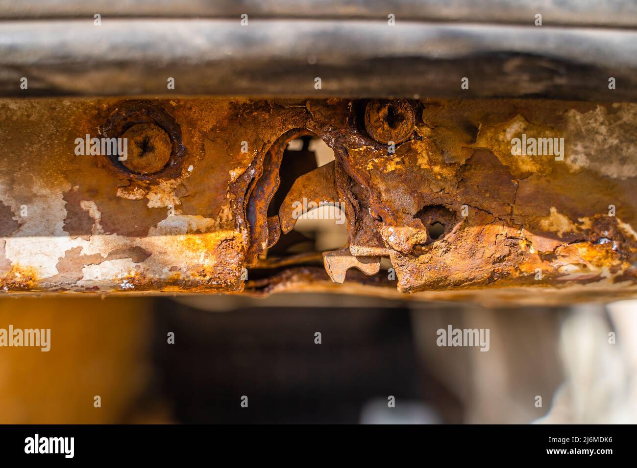 Rusty car door lock. A rotten lock mount on a minivan liftgate. body