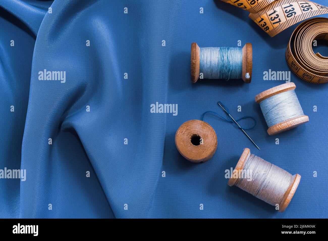 Vintage retro spool of thread on a black and white fabric background