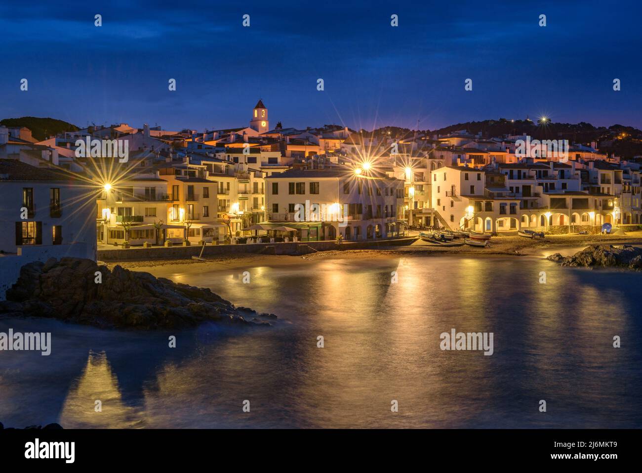 Blue hour and sunrise in the fishing village of Calella de Palafrugell, with its boats and white houses, Costa Brava Empordà, Girona, Catalonia, Spain Stock Photo