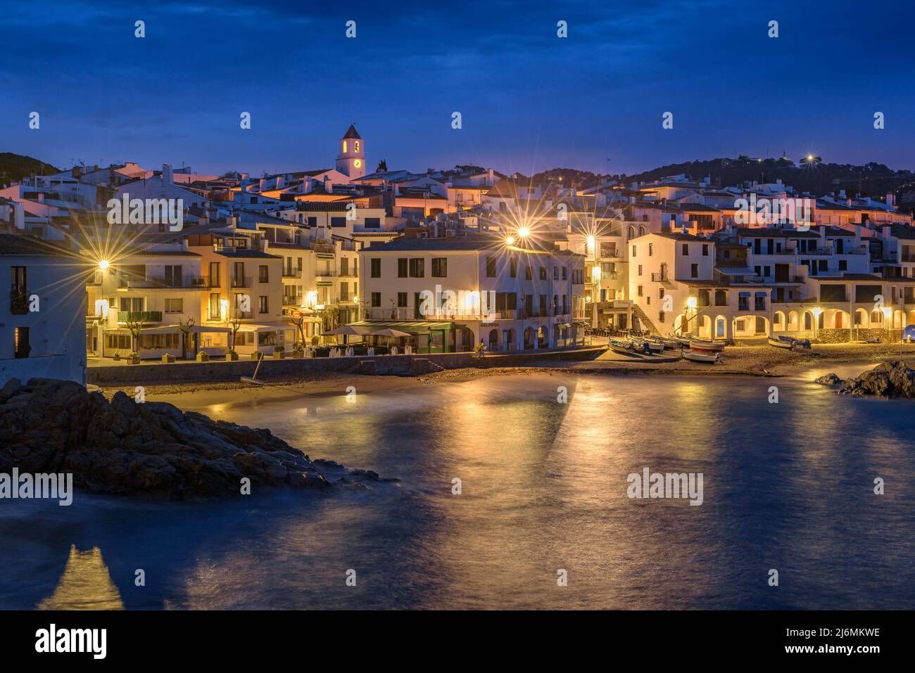 Blue hour and sunrise in the fishing village of Calella de Palafrugell, with its boats and white houses, Costa Brava Empordà, Girona, Catalonia, Spain Stock Photo