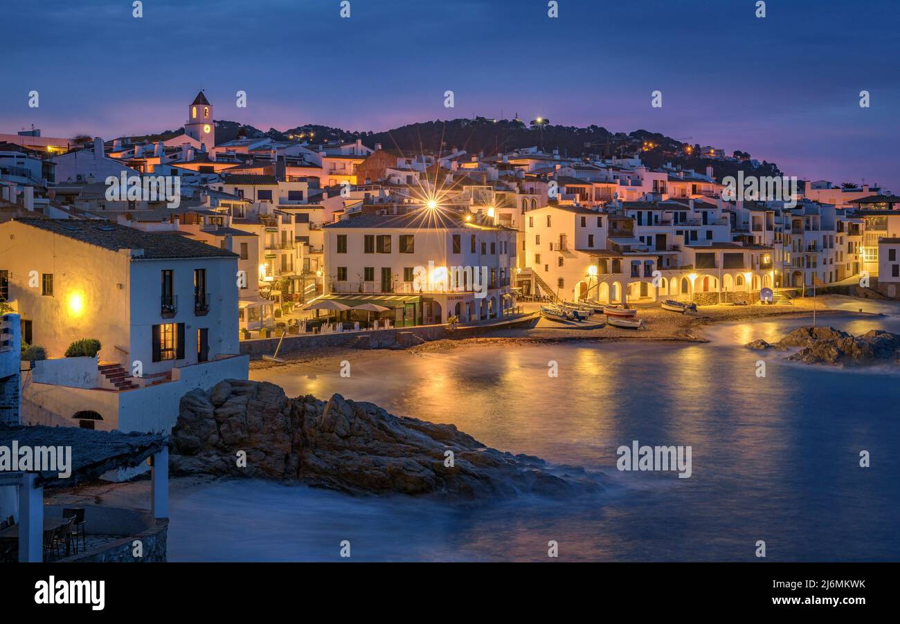Blue hour and sunrise in the fishing village of Calella de Palafrugell, with its boats and white houses, Costa Brava Empordà, Girona, Catalonia, Spain Stock Photo