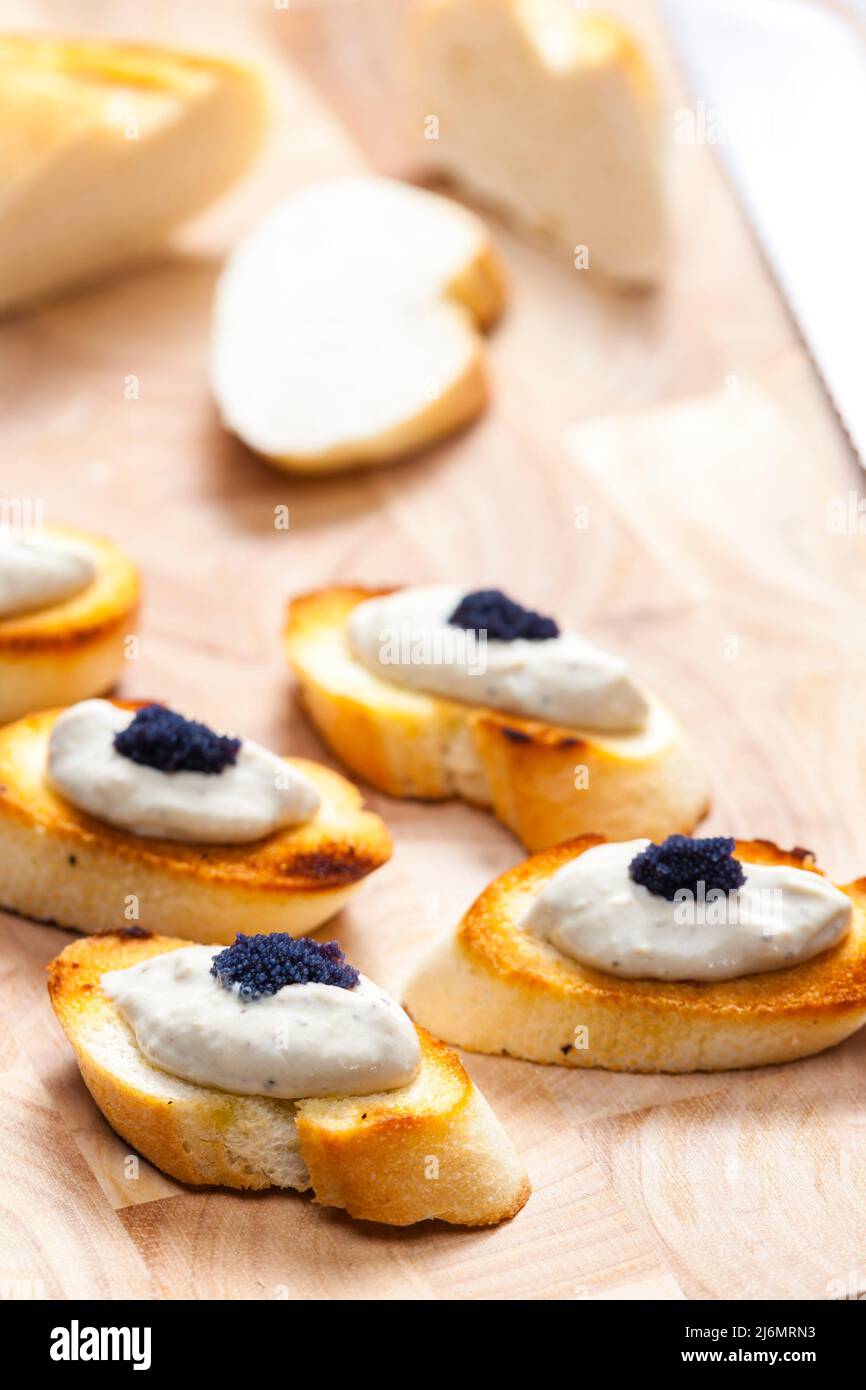anchovy spread on toasted baguette slices Stock Photo Alamy