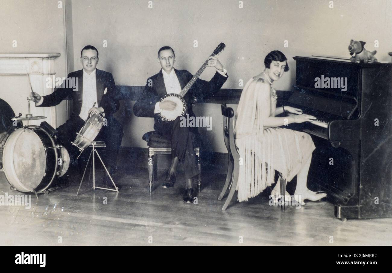 Archival sepia toned photograph of 'Bonzo Trio' jazz band, 1927, England. Jack Jim and  pianist Doll Mather in a flapper dress Stock Photo