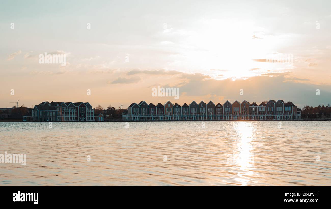 Colorful houses beside the lake at dusk in Houten, Utrecht, Nehterlands Stock Photo