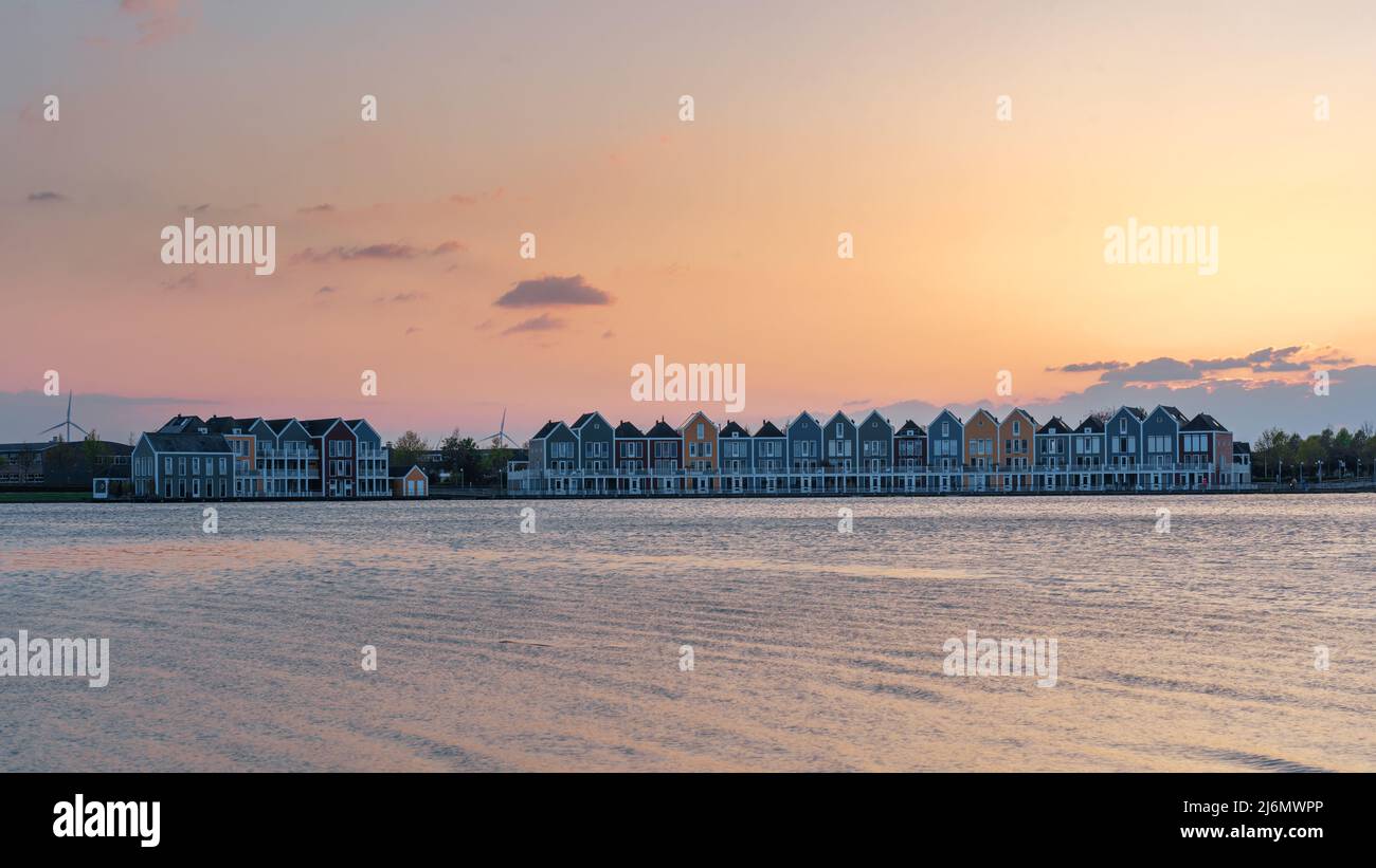 Colorful houses beside the lake at dusk in Houten, Utrecht, Nehterlands Stock Photo