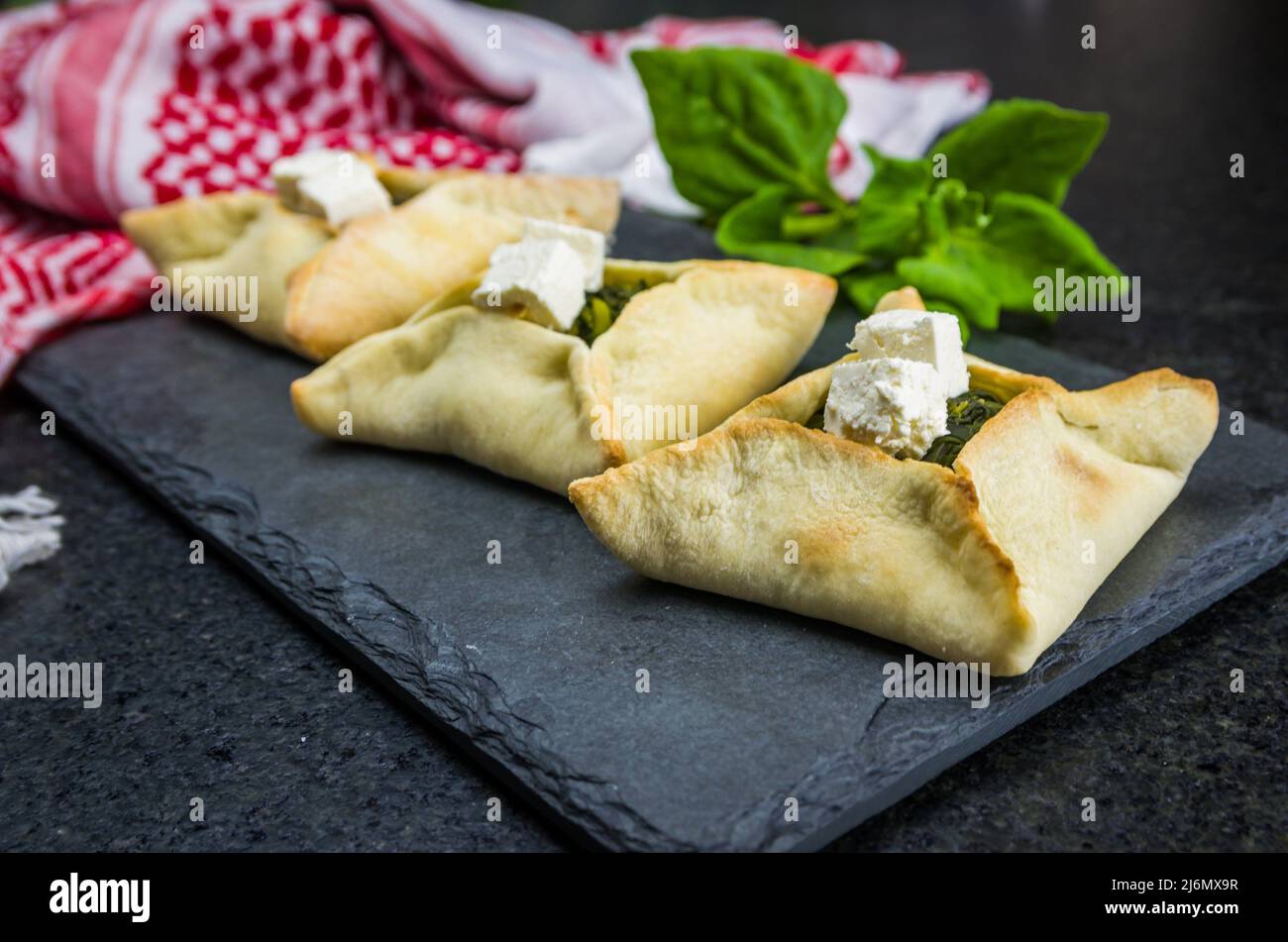 Delicious Lebanese (Arabic) food, spinach sfiha with ricotta cheese on