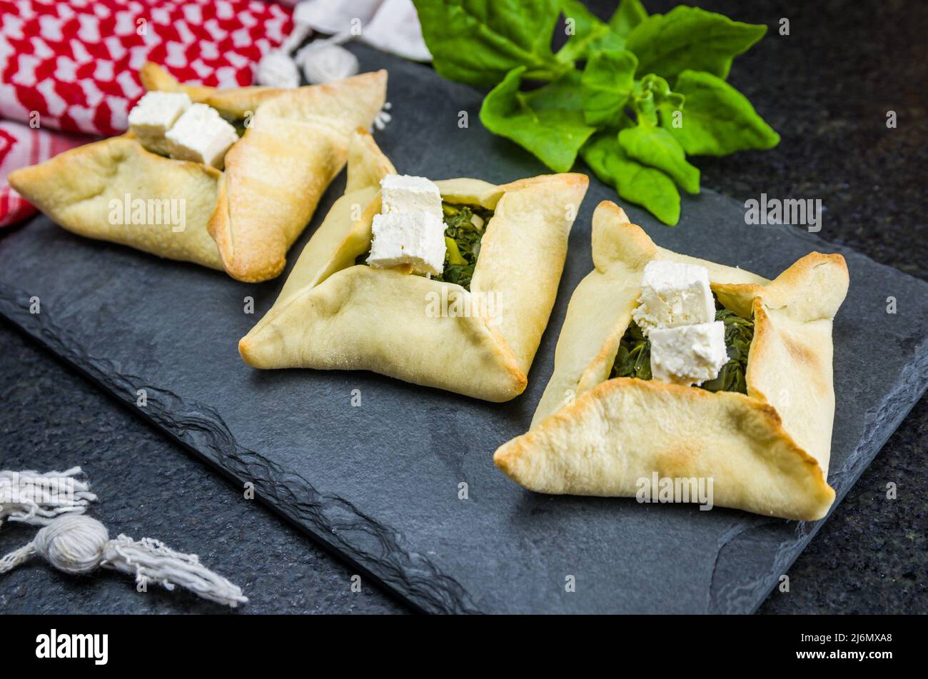 Delicious Lebanese (Arabic) food, spinach sfiha with ricotta cheese on
