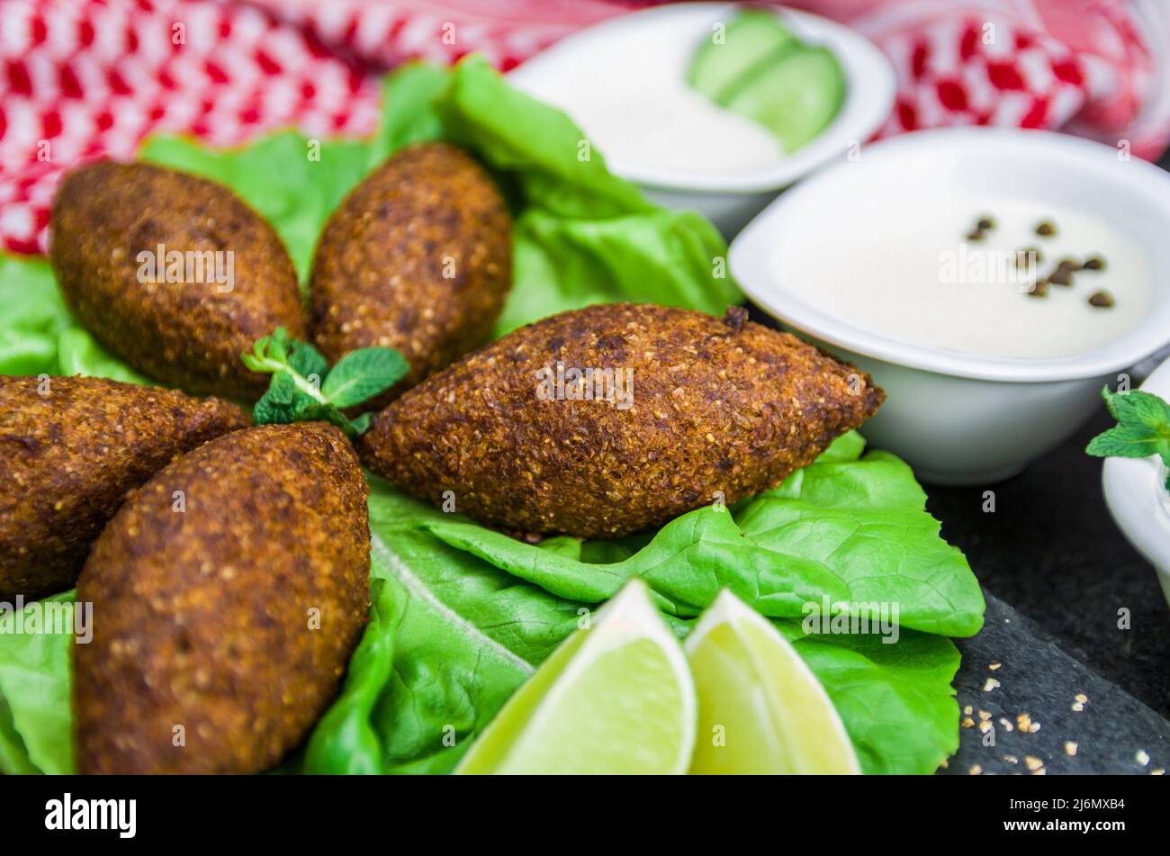 Delicious Lebanese (Arabic) food, kibbeh (kibe) with sauces and lemon