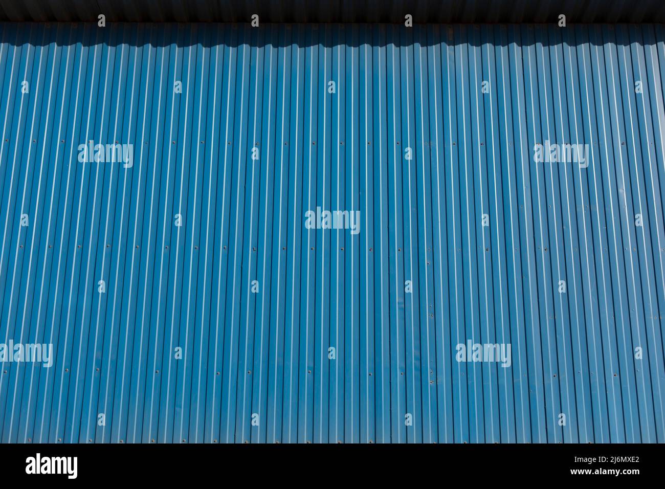Blue fence. Fence made of profile sheet. Metal fence Stock Photo Alamy