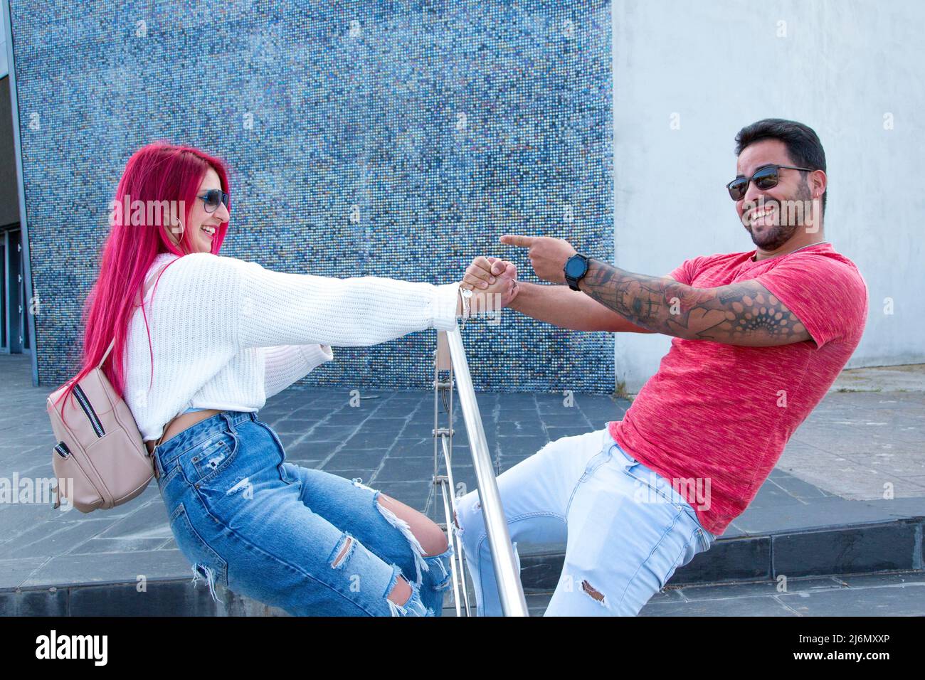 young couple holding hands having fun Stock Photo