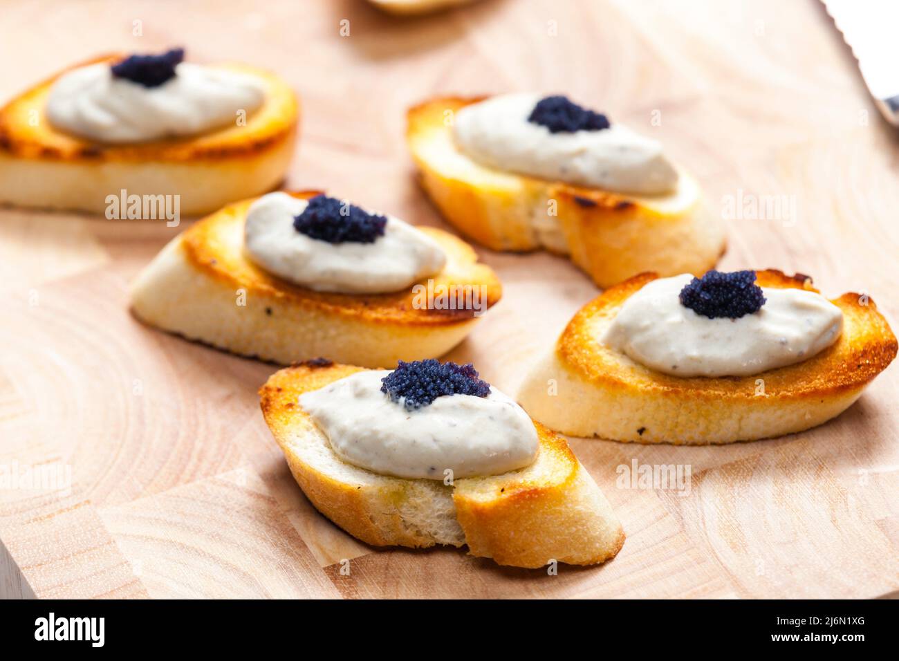 anchovy spread on toasted baguette slices Stock Photo Alamy
