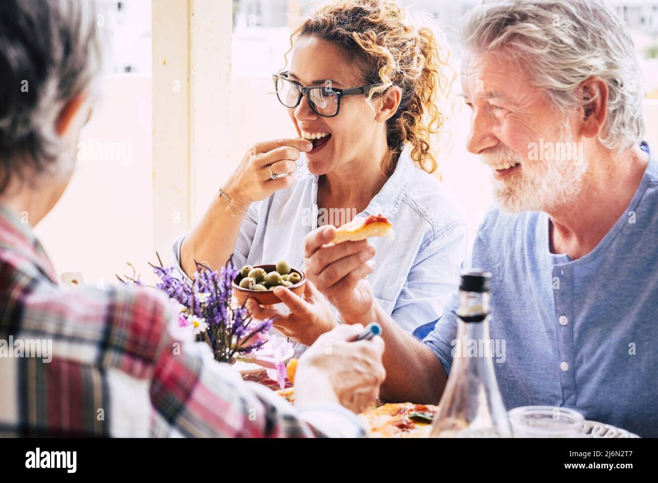 People having fun and having lunch on dining table. Spending quality
