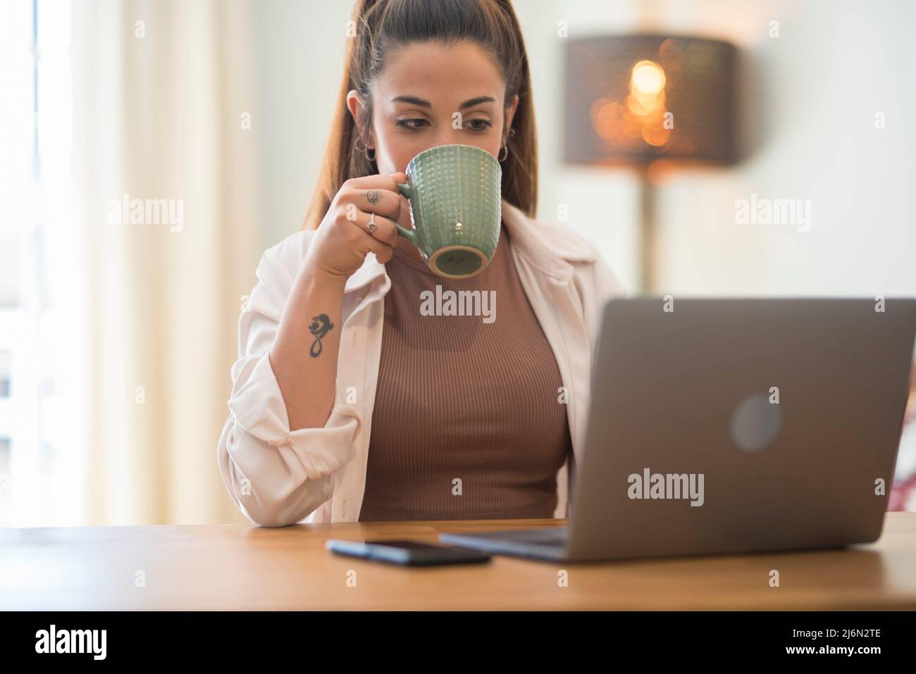 Portrait of caucasian young Woman working and typing on laptop computer keyboard - office and smart working job concept for professional business or Stock Photo
