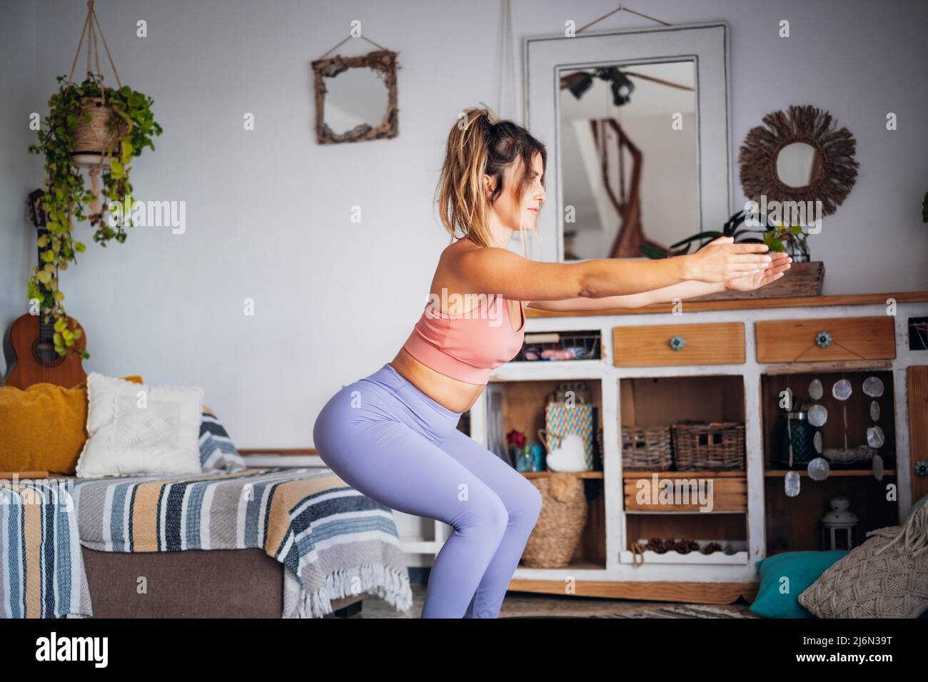 Beautiful girl sport at home. Fitness exercise, abs , smart training, exercise, home workout - push up balanced position for healthy lifestyle people Stock Photo