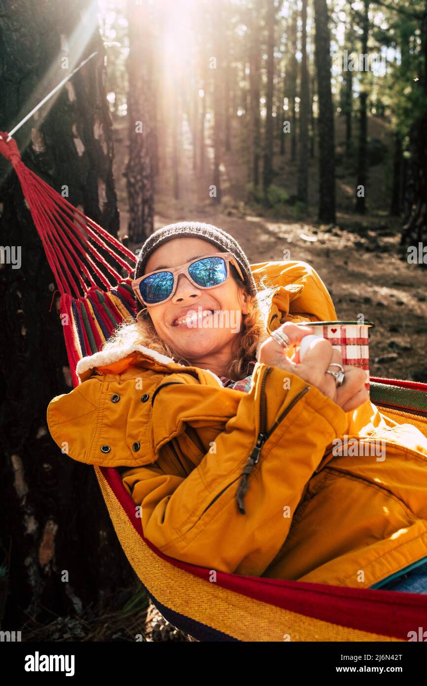 Portrait of beautifu woman smile and enjoy relax and freedom outdoor leisure activity in the forest woods park - high trees and sunlight in Stock Photo