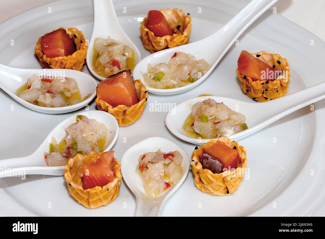 Tapa appetizer of esqueixada spoons and gllet voulevant tartlet with