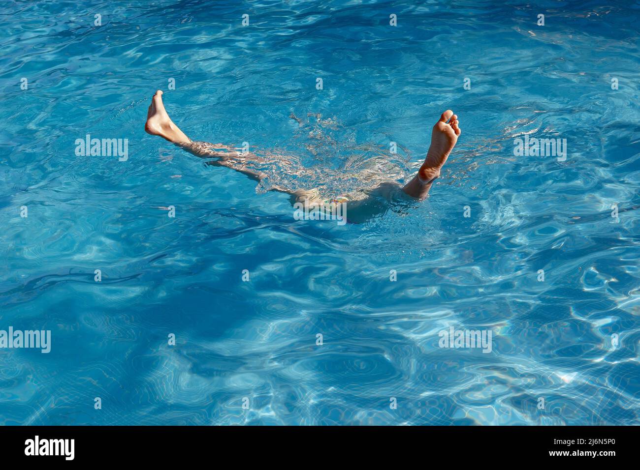feet sticking out of a pool water Stock Photo Alamy