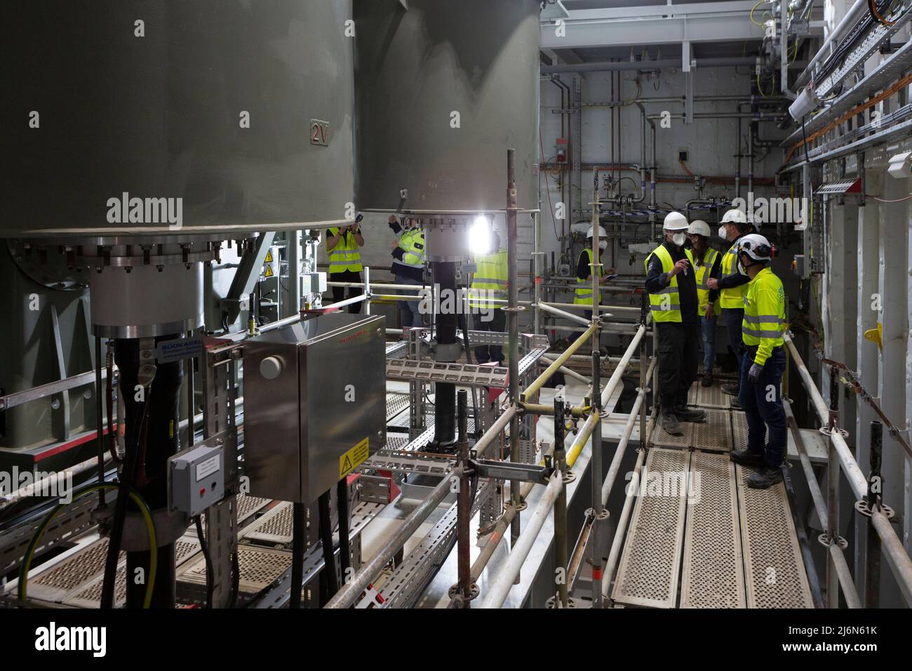 PRODUCTION - 25 April 2022, Spain, Cadiz: Visitors stand inside the DolWin  kappa offshore converter platform, which is being built at the Dragados  Offshore shipyard in Cadiz. The DolWin6 offshore platform will