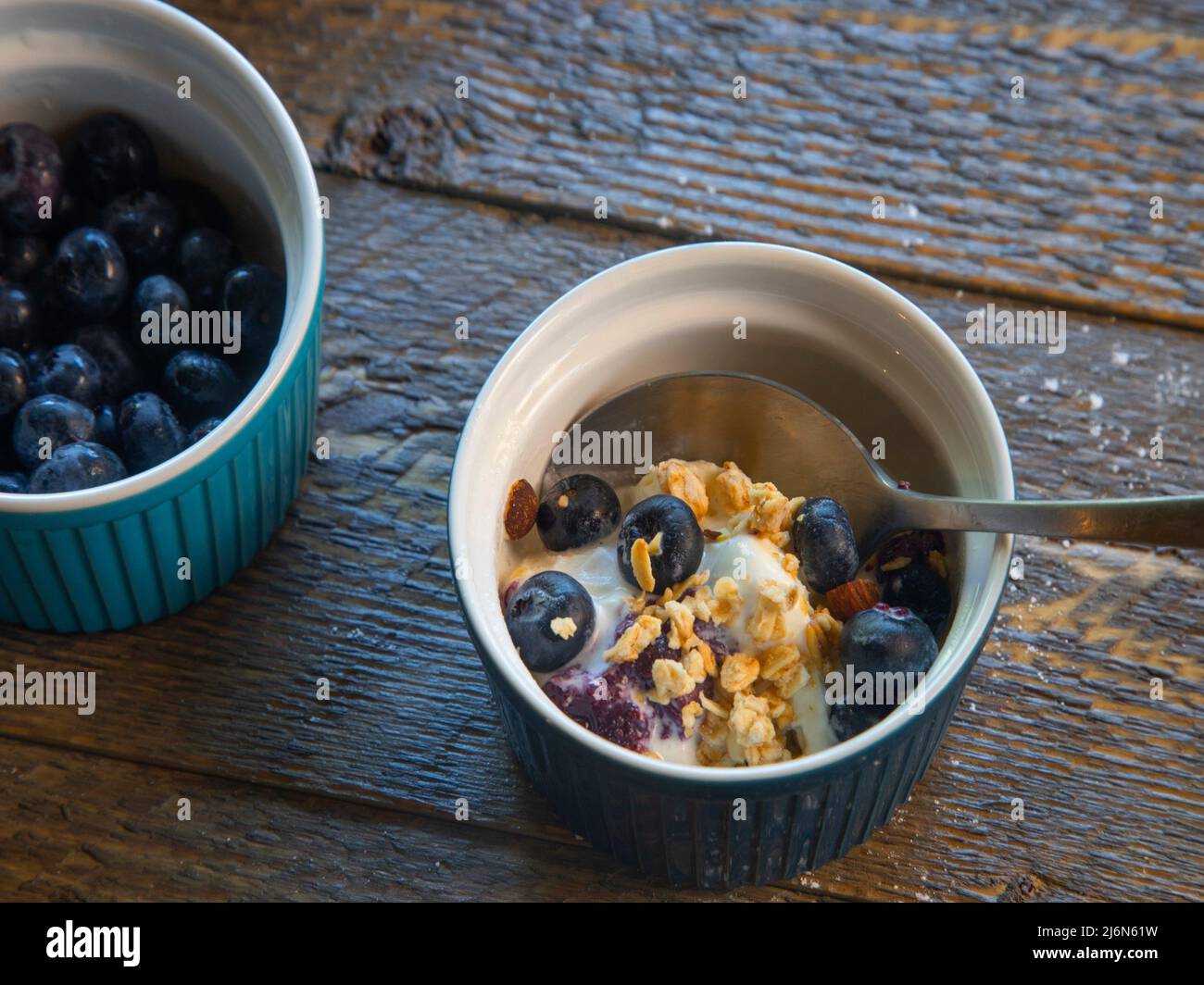 Top view of blueberry ice cream granola dish on natural wood table. Stock Photo