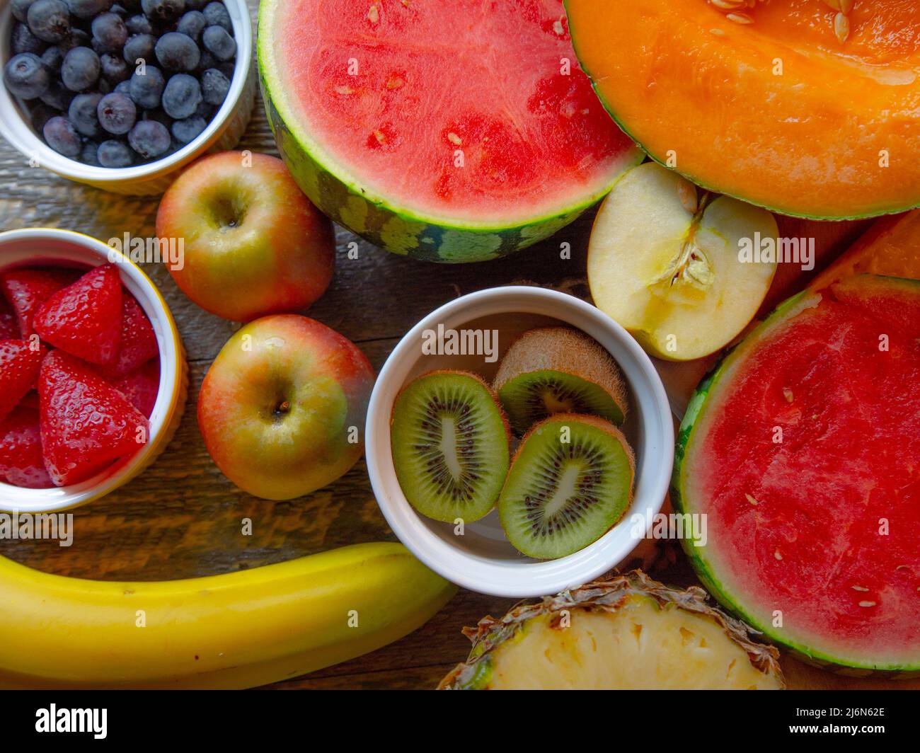 Top View of fresh cut fruit on natural wooden table. Stock Photo