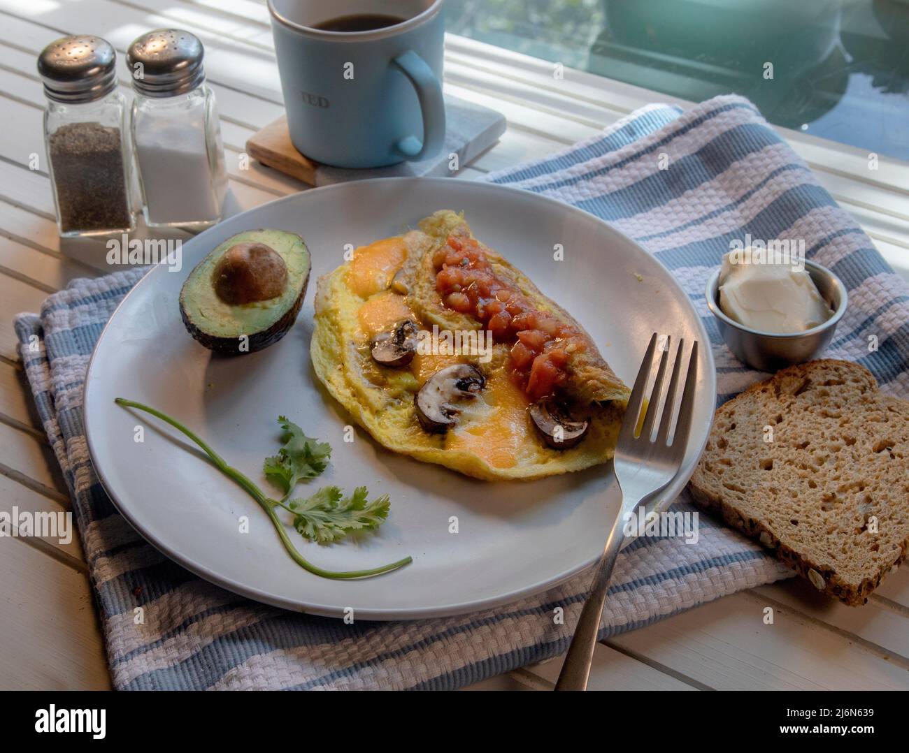 Top View of mushroom and cheese omelette on white natural wood table. Stock Photo