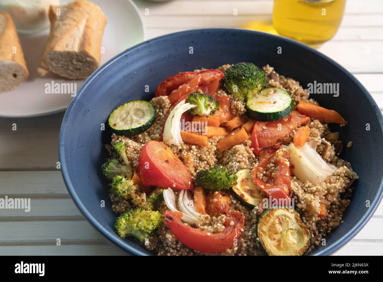 Top view of quinoa salad on white natural wood surface. Stock Photo