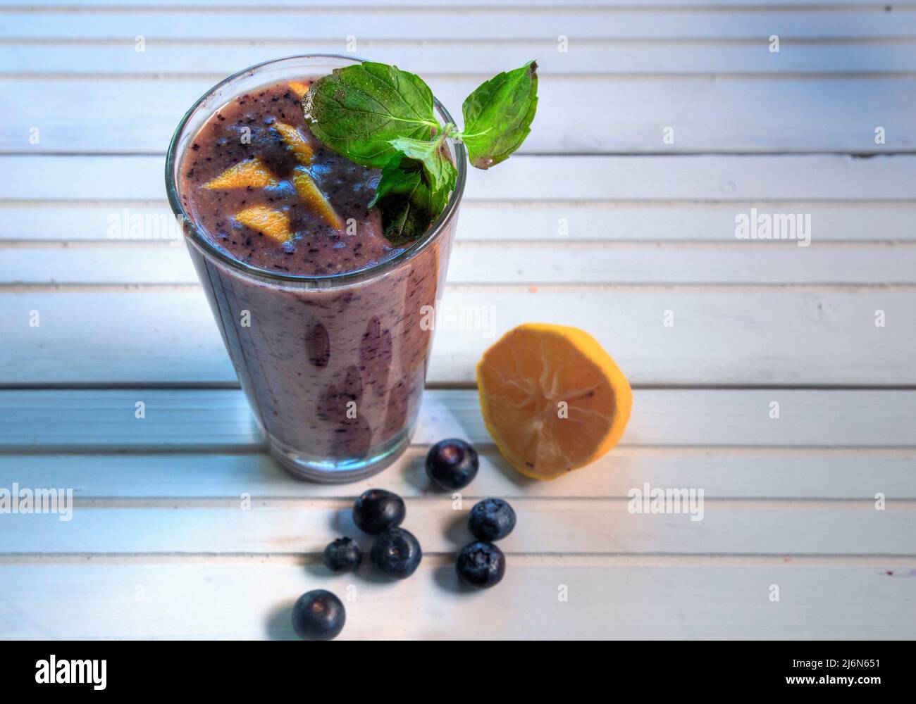 Top view of blueberry smoothies on natural white wood surface. Stock Photo