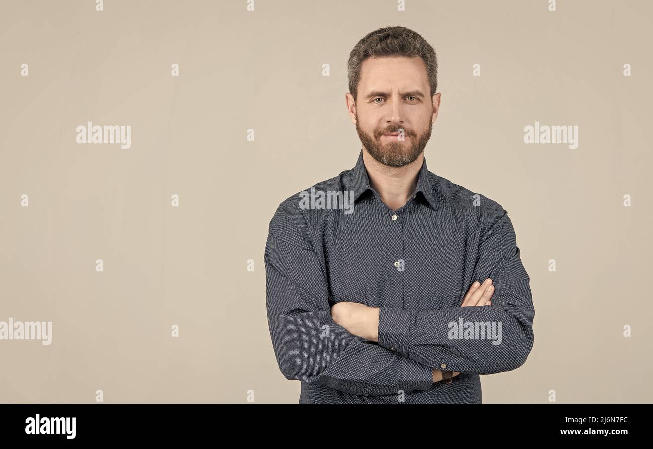 Confident man wear casual shirt keeping arms crossed grey background, informal clothing, copy space Stock Photo