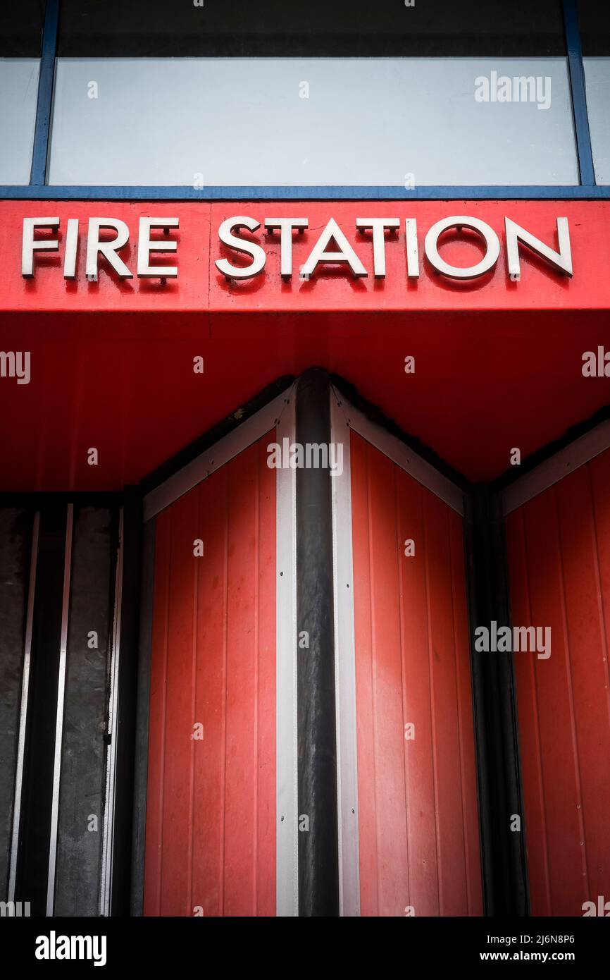 Fire station sign against bright red background Stock Photo