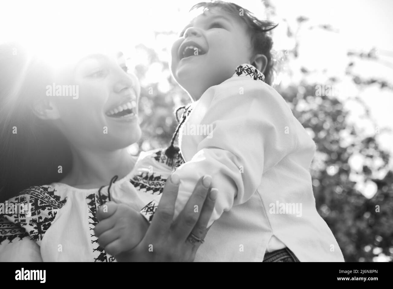 Happy woman and child in the blooming spring garden. Mothers day holiday concept Stock Photo