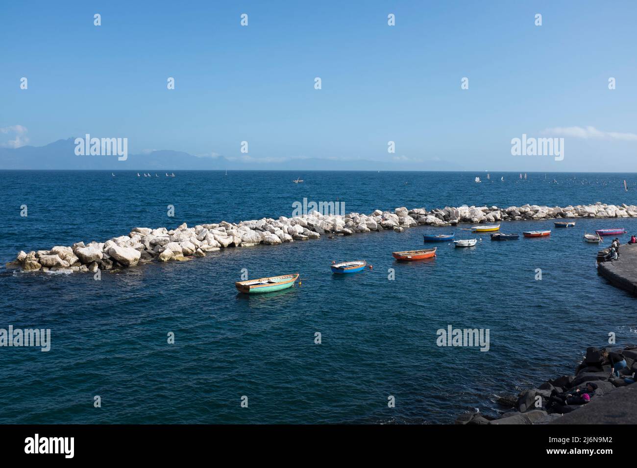 Fishing Boats in the Bay of Naples looking towards from Lungomare di Napoli Mount Vesuvius Naples Italy Stock Photo