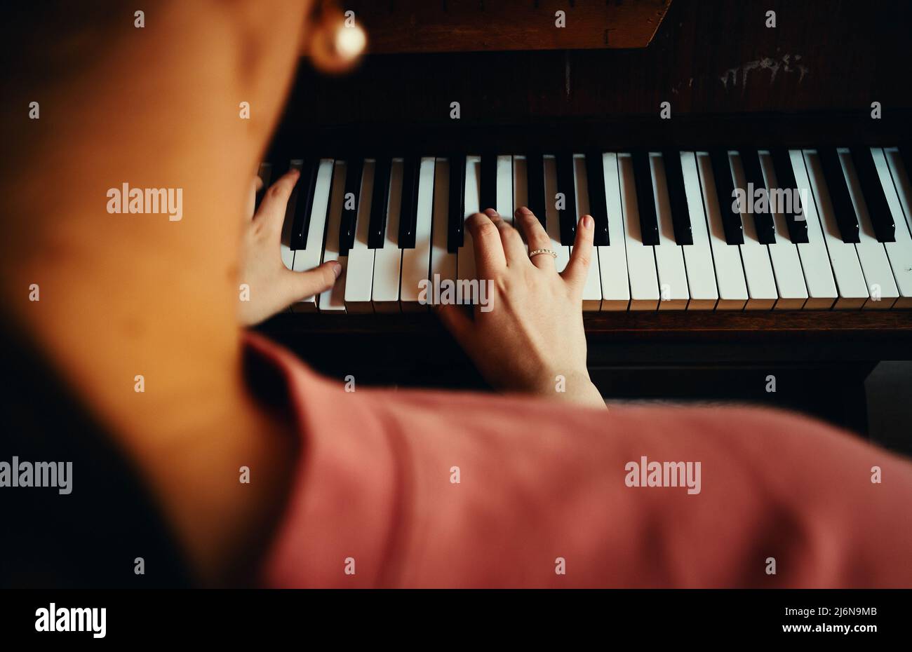 Girl is practicing playing the piano, close-up view. Stock Photo