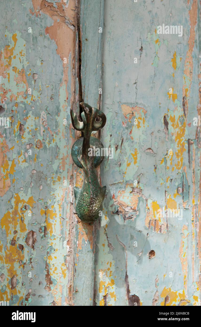 Decorative door knocker on a wooden door from Malta, door knob Dophin. Malta, traditional door,  knocker Stock Photo