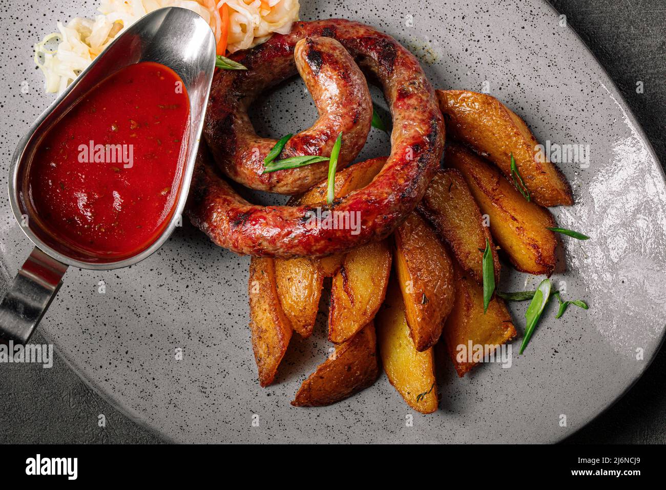 German sausage with sauerkraut and potato Stock Photo Alamy