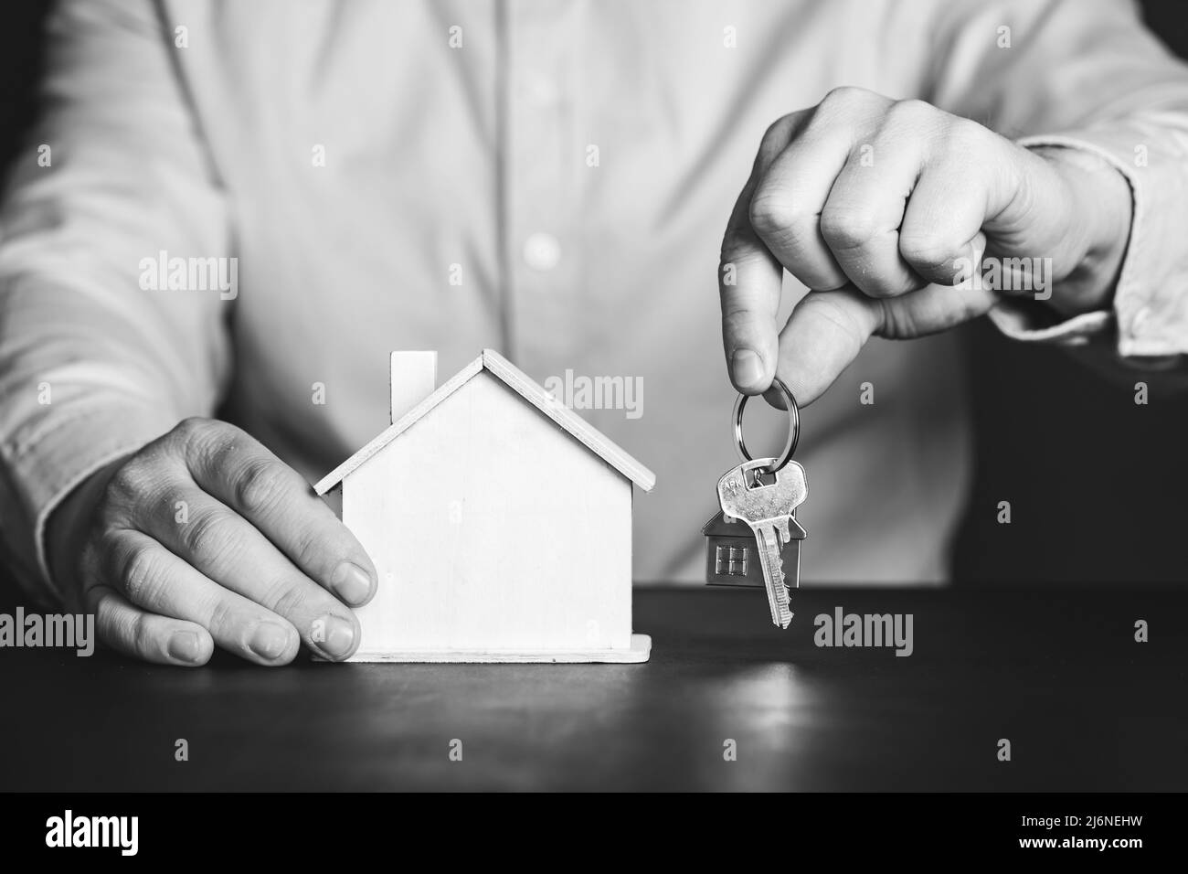 Businessman holding wooden house model and house key.Real estate, home ...